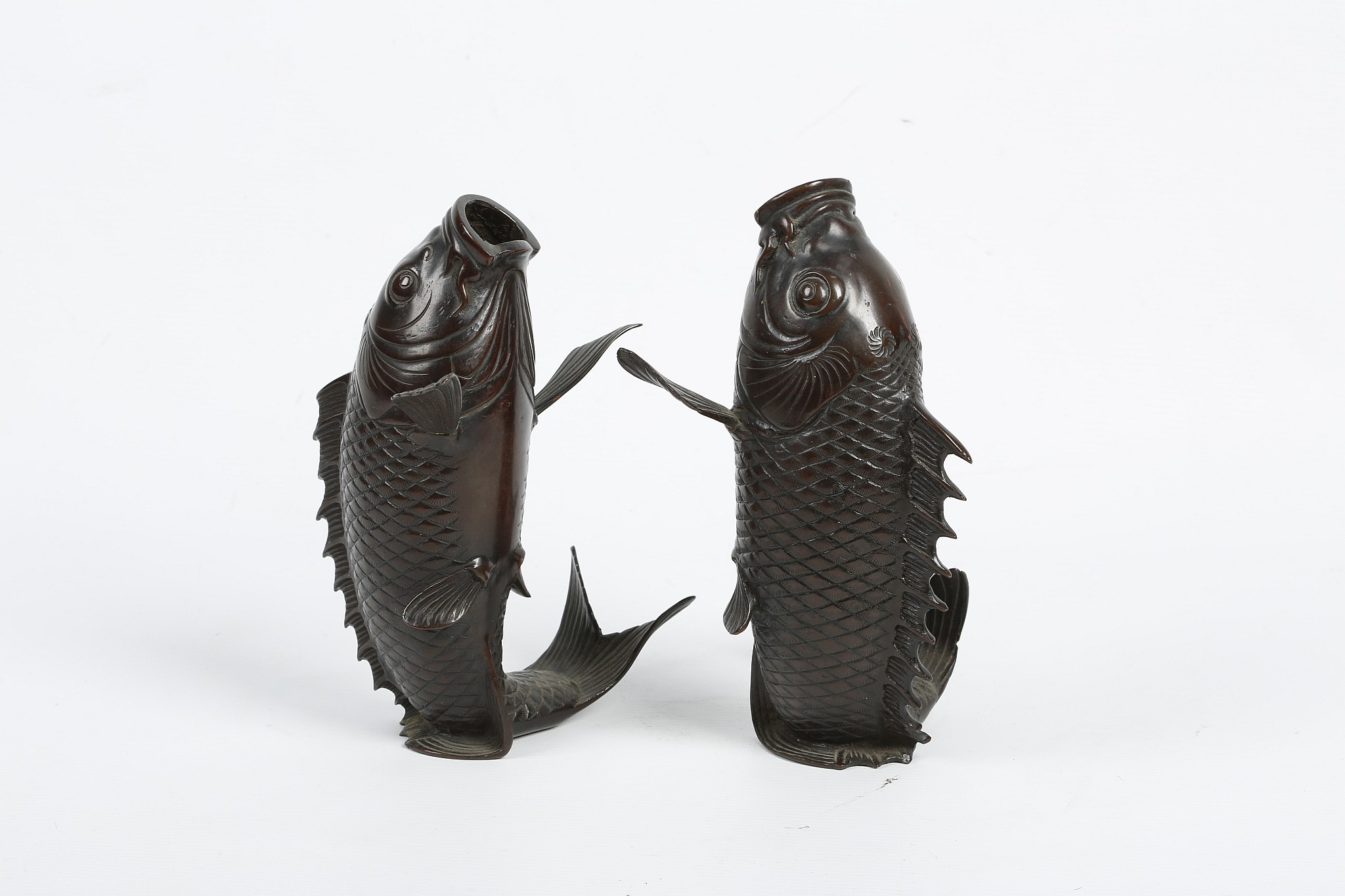 A PAIR OF JAPANESE ‘LEAPING CARP’ VASES. Meiji era. Naturalistically cast resting on their fins, the