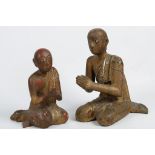 TWO BURMESE CARVED WOODEN PRAYING FIGURES. 19th Century. (2)