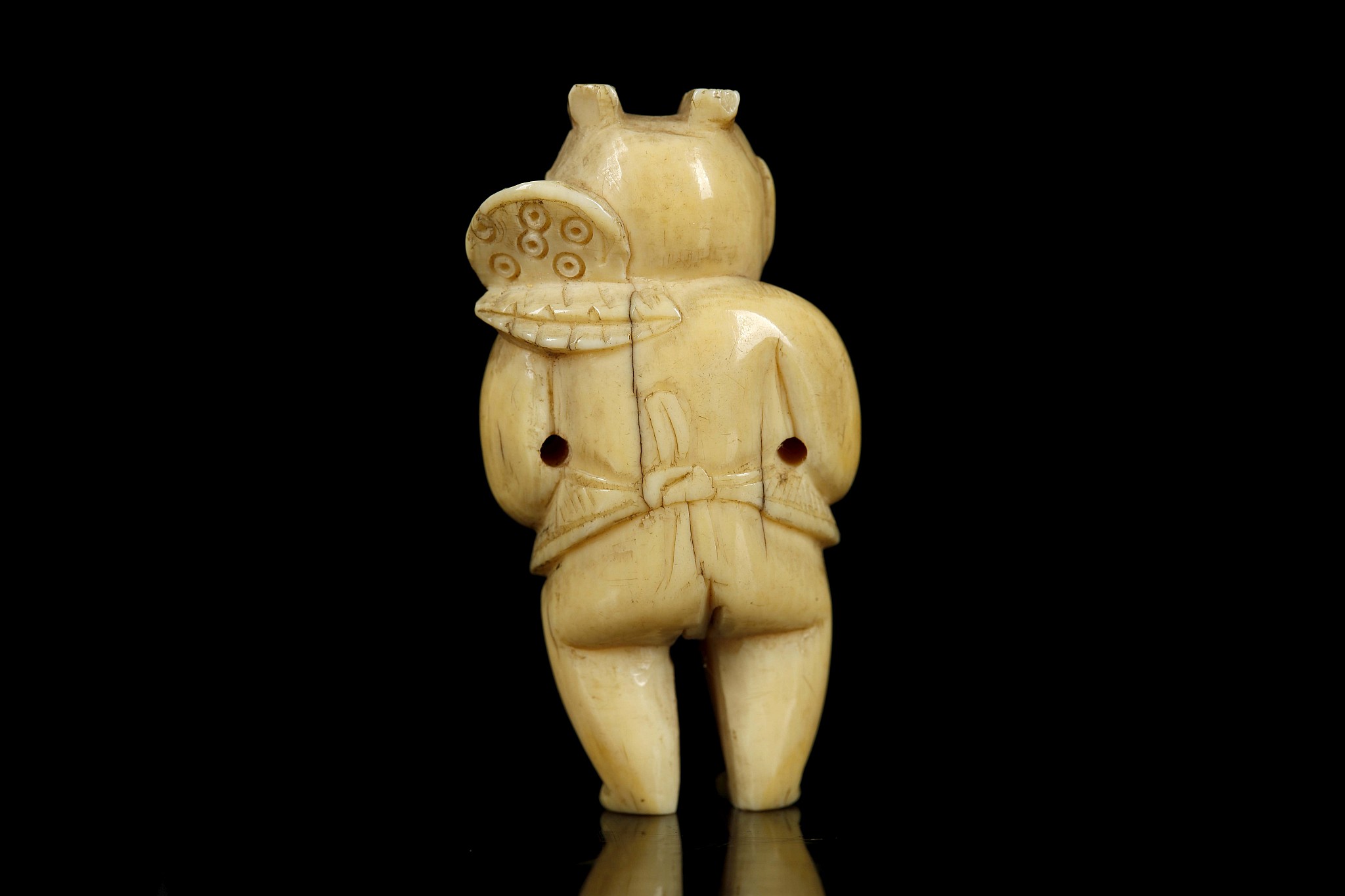 A JAPANESE IVORY NETSUKE FORMED AS A BOY. Meiji Period. Carved standing and holding a lotus - Image 3 of 6