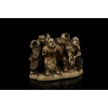 A JAPANESE CARVED IVORY NETSUKE. Signed Masamine, Meiji Period. Carved as a group of dancers, 3cm
