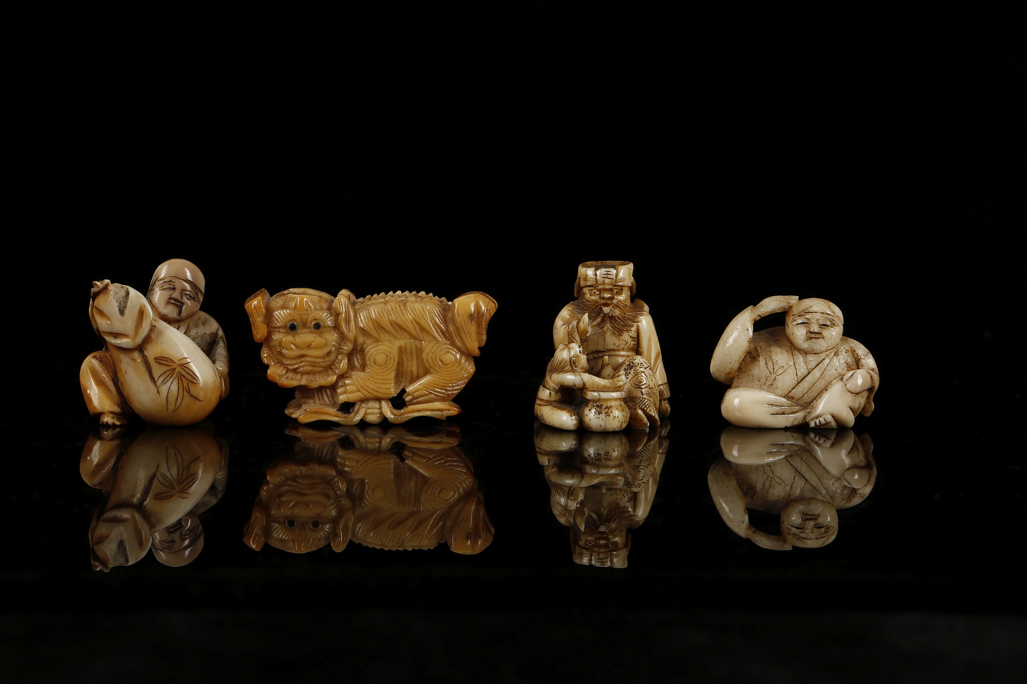 A COLLECTION OF FOUR JAPANESE NETSUKE. Two carved ivory and two carved bone. (4) - Image 2 of 7