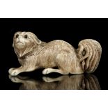 A JAPANESE CARVED IVORY FIGURE OF A PUPPY. 19th Century. 7cm long.