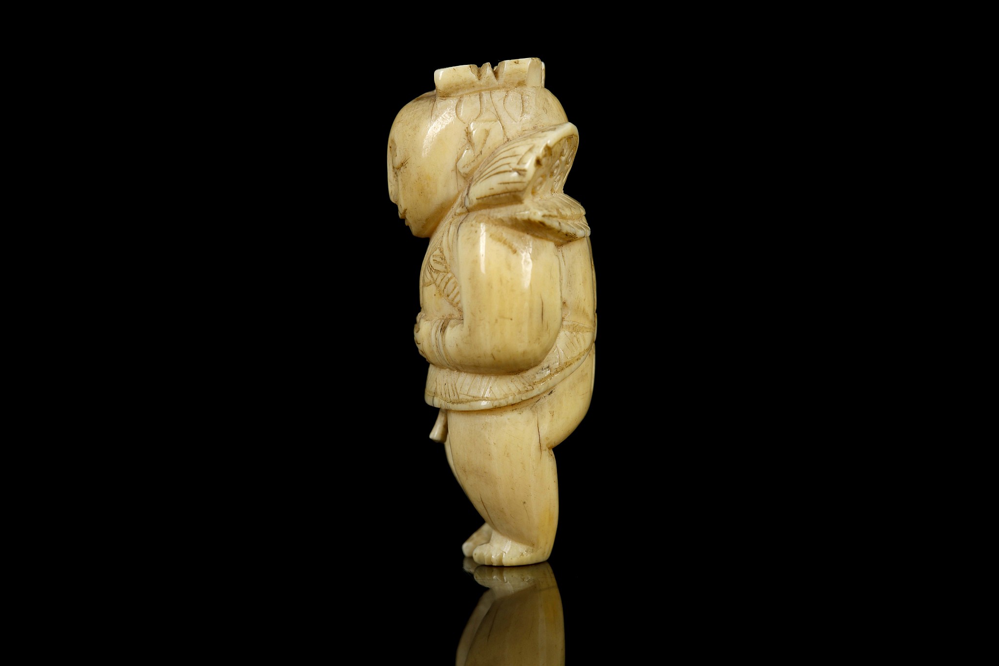 A JAPANESE IVORY NETSUKE FORMED AS A BOY. Meiji Period. Carved standing and holding a lotus - Image 4 of 6