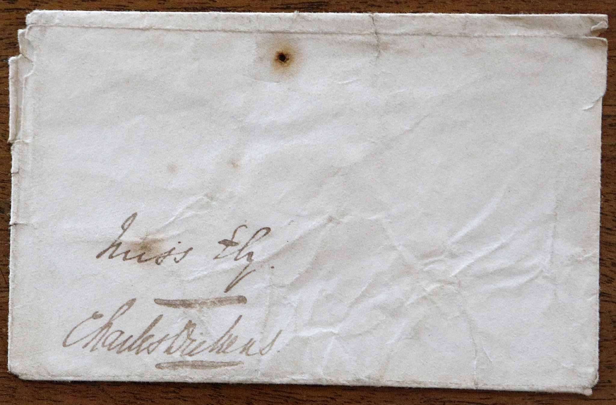 DICKENS, Charles (1812-70). An envelope addressed to "Miss Ely", SIGNED by Dickens. With 2 annual