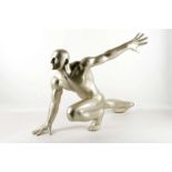A silvered modern resin model of a crouching athlete.