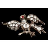 An antique silver/gold and diamond set bird brooch
