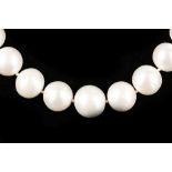 A large string of cultured pearls with silver magn
