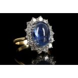 An 18ct gold, cabochon sapphire and diamond set cl