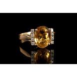 A 14ct gold, topaz and diamond set ring, the oval