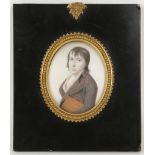 Attributed to Jeremiah Meyer R.A. 1725-1796. Portrait miniature of a young man carrying a book