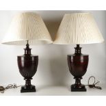 A pair of large mahogany turned lamp bases, with cream silk shades, 78cm.