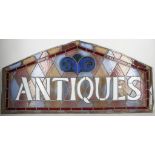 A stained glass panel 'antiques'.