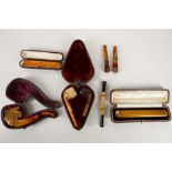 A good selection of historic smokers items comprising; a gold and ivory cheroot holder, a Meerschaum