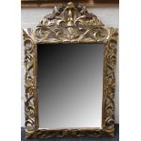 A large early 20th century, French gilded wall mirror in 'Empire' manner, cornice carved with two
