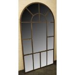 A palladian style wall mirror with an arched, architectural metal frame, 110 x 206cm.