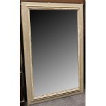 A large rectangular mirror, the frame painted green with a distressed finish, 94 x 159cm.