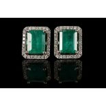 A pair of 18ct white gold, emerald and diamond cluster earrings. Emeralds: 4.81ct total. Diamonds: