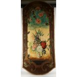 A decorative trompe l'oeil wall panel, painted with flowers on a ledge in a vase.