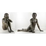 A pair of bronze garden figures, depicting 2 seated girls, mid 20th century, approx 65cm high (2).