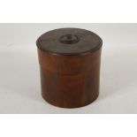 A cylindrical section bitong-form hardwood box and cover, the cover with turned decorative