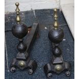 A pair of Georgian wrought iron fire dogs with brass finials.