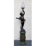 A putti holding a flambe lamp on a fluted column support.