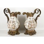 A pair of French decorated ewers, heavy brass acanthus spout, handle and mount, floral swags,