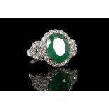 An 18ct white gold, emerald and diamond set cocktail ring. Emerald: 5ct. Diamonds: 1.39ct. Size: