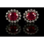 A pair of 18ct white gold, ruby and diamond cluster earrings. Ruby: 4.65ct (treated). Diamonds: 0.