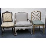 A Louis XV style open armchair, having light grey upholstery, another continental carved side