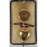 An 18ct gold and garnet pendant, sold together with a yellow metal and diamond set heart shaped