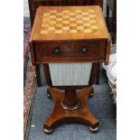 A Victorian mahogany games table, with chequer board top and drop flaps, single drawer on platform