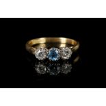 An 18ct gold / platinum, zircon and diamond three stone ring. Zircon: 0.25ct. Diamond: 0.40ct