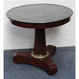 A French Empire reception room circular table, black marble top with fossil inclusions, flame