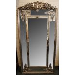 A French silvered frame mirror with decorative crest over mirrored slips, with decorative