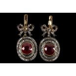 A pair of 14k gold / gold washed silver, ruby and diamond cluster drop earrings with ribbon scroll