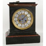 An aesthetic movement, black enamelled marble cased mantel clock by John Walker of London, having