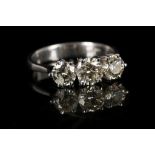 An 18ct white gold and diamond three stone ring. Diamond: 1.42ct total. Size: L½.