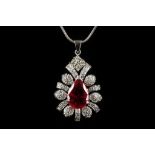 A high carat white gold, red tourmaline and diamond set cluster pendant, suspended from a .925