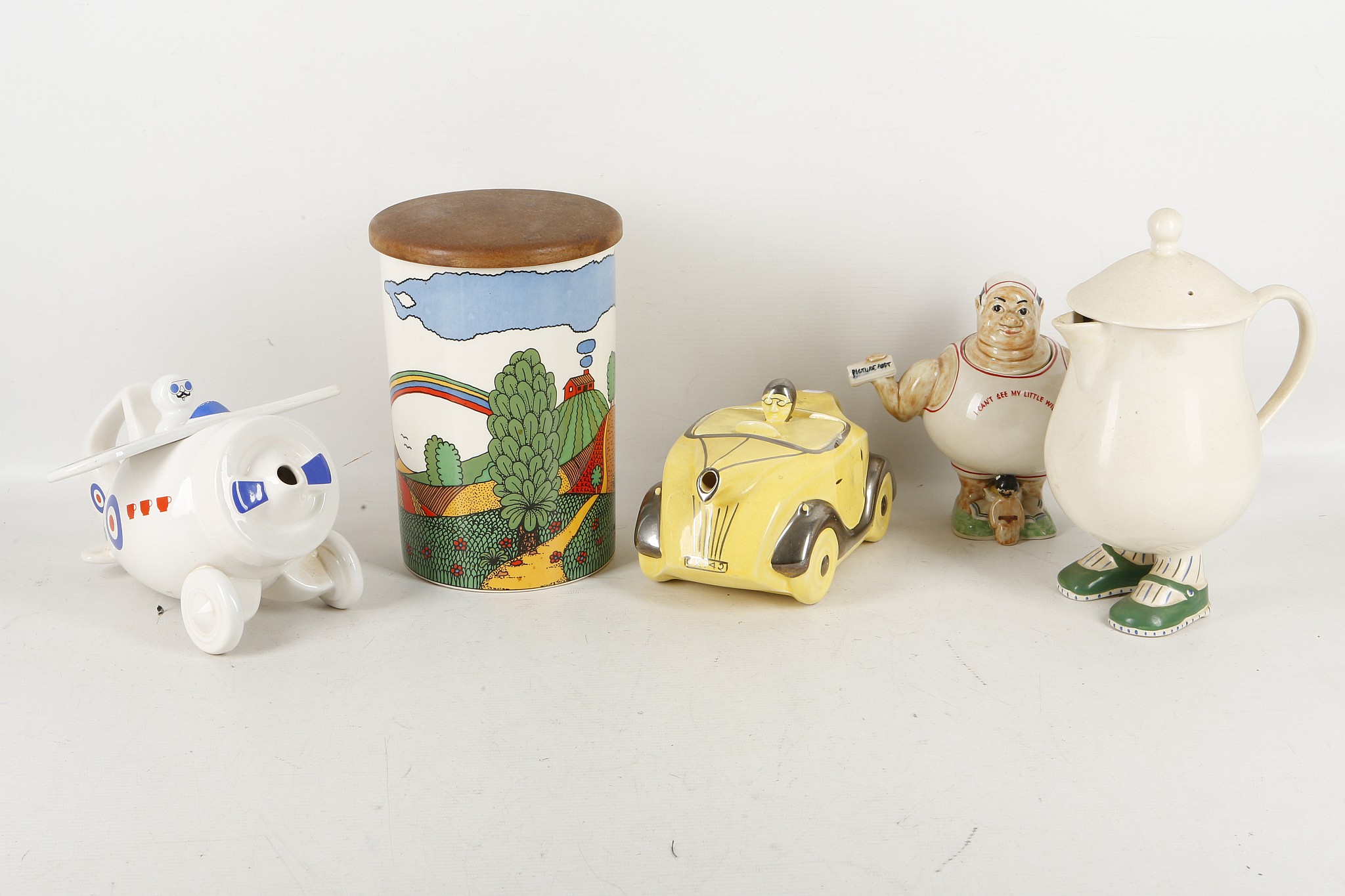 A collection of four 1930's and later novelty teapots and a Crown Devon biscuit barrel by Robin Cody