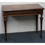 A late 19th century, French fruit wood game table on four tapering legs with folding top.