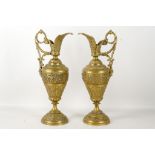 A pair of late 19th century renaissance style bronze ewers, having deep cast foliate detail and