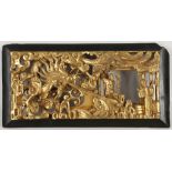 A Chinese carved wood, gold painted panel decorated with figures beside a 'dragon and fish'.