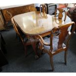 A burr walnut dining suite c.1950, comprising a table with leaf trim, acanthus carving to legs, ball