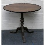 A George III style mahogany occasional pedestal table, with fluted and carved column on three scroll