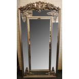 A French silvered frame mirror with decorative crest over mirrored slips, with decorative