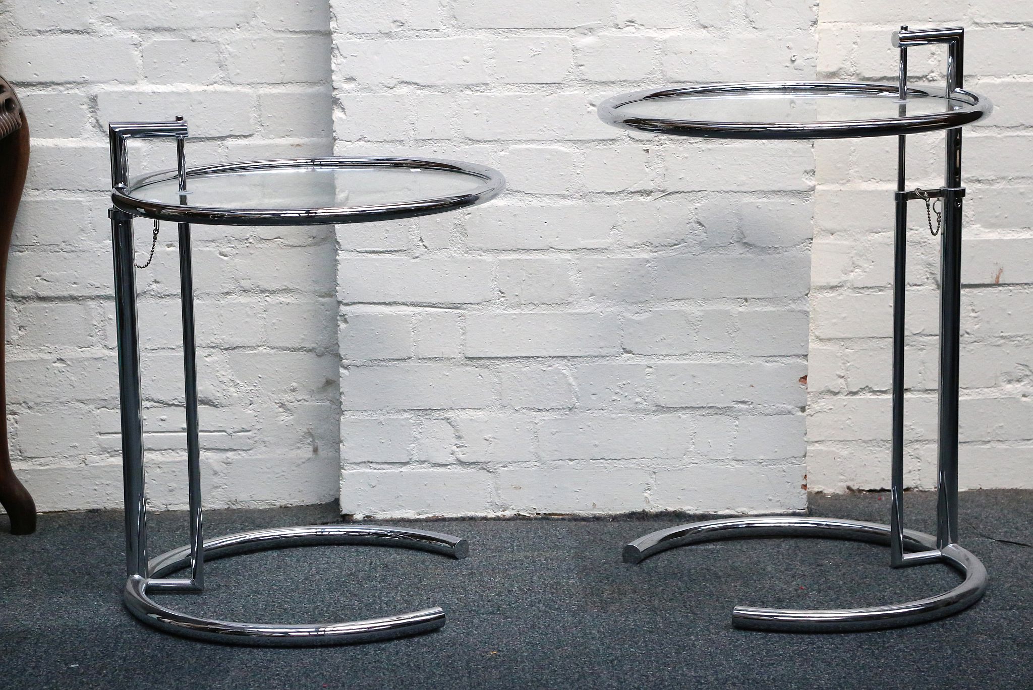 A pair of Eileen Gray E1027 style side tables, wit