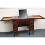 A Georgian mahogany dressing table, with two hinged lids opening to reveal a parcel gilt framed