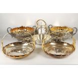 A collection of highly ornate silver plated dishes