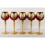 A set of five cranberry glass hock glasses, each d